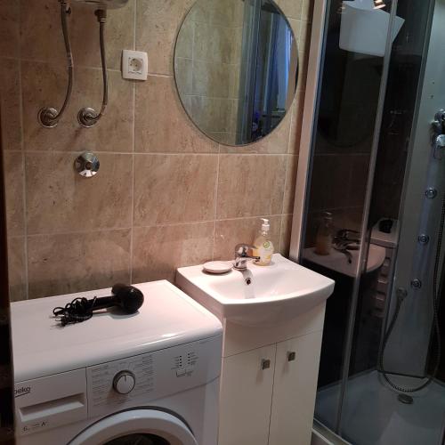 a bathroom with a washing machine and a sink at Apartment Katerina in Supetar