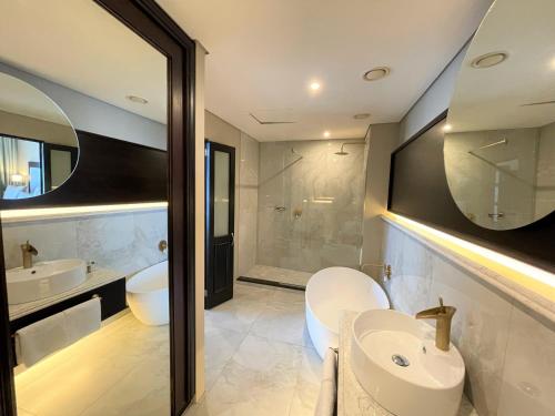 a bathroom with a sink and a toilet and a tub at Premier Hotel Cape Town in Cape Town