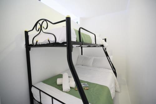 a black bunk bed in a white room at La Bella Boutique Hotel in Tagaytay