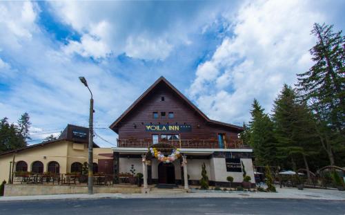 a building with a sign that reads volka inn at Voila Inn Predeal in Predeal