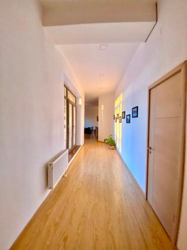 an empty hallway in an apartment with white walls and wooden floors at Gobi-Girl in Ulaanbaatar