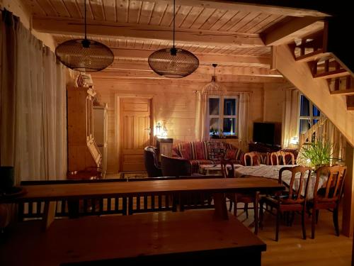 a living room with a table and chairs at Święty Spokój Łąka i Woda in Pozezdrze