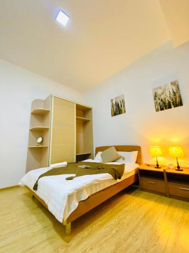 a bedroom with a bed and two night stands and two lamps at Gobi-Girl in Ulaanbaatar