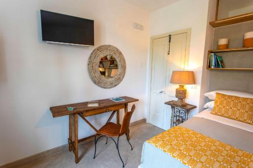 a bedroom with a desk and a bed and a bed and a bed at Masseria Ferarelli Trepizzi in Diso