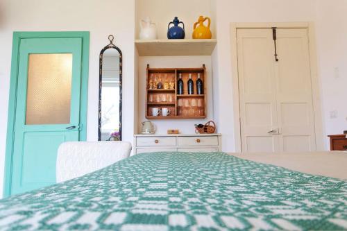 a bedroom with a bed with a blue door at Masseria Ferarelli Trepizzi in Diso