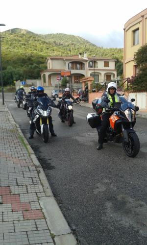 a group of people riding motorcycles down a street at Hotel Jasmine in Teulada