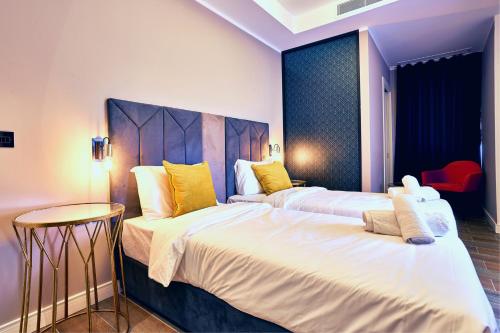 a hotel room with two beds and a table at Cinematique in Mosta