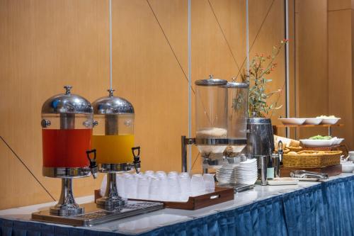 a table with a buffet of food and drinks at Holiday Inn Express Chengdu Xindu by IHG in Chengdu