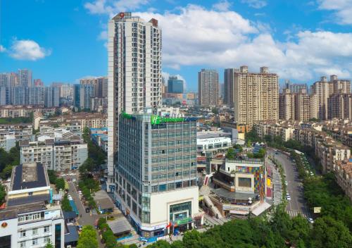 a city skyline with a tall skyscraper at Holiday Inn Express Chengdu Xindu by IHG in Chengdu