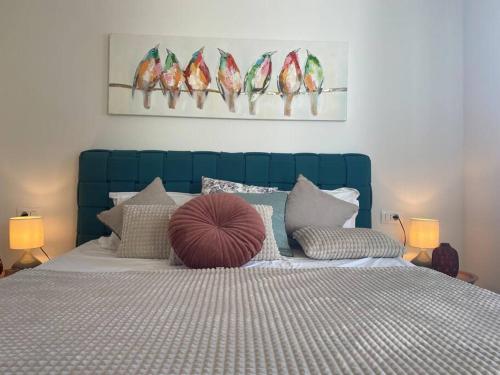 a bedroom with a bed with a blue head board at Sunrise Makarska in Makarska