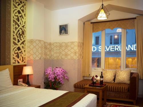 a hotel room with a bed and a window at Vilion Boutique Hotel Ben Thanh in Ho Chi Minh City