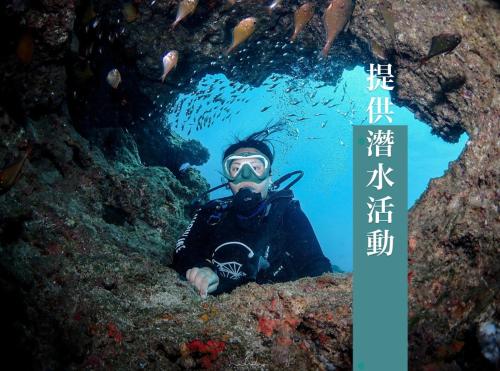a man in a snorkel mask in a underwater cave at A Forest Homestay in Xiaoliuqiu