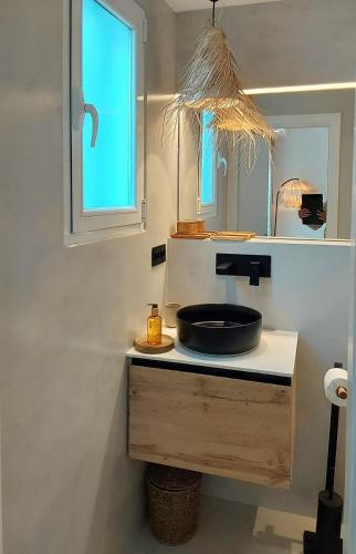 a bathroom with a sink and a mirror at Havana Penthouse in Cala Ratjada