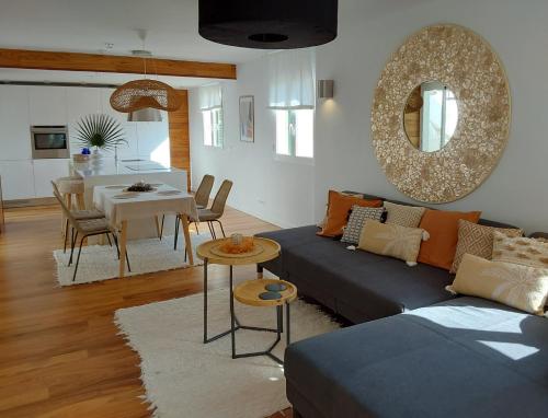 a living room with a couch and a table at Havana Penthouse in Cala Ratjada