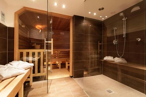 a bathroom with a shower and a walk in shower at Aussen Alster Hotel in Hamburg