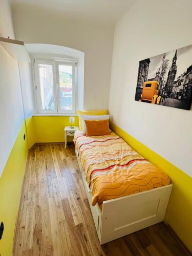 a small bedroom with a bed in a room at Apartment Tashi, Korzo - Rijeka, 2 bedrooms in Rijeka