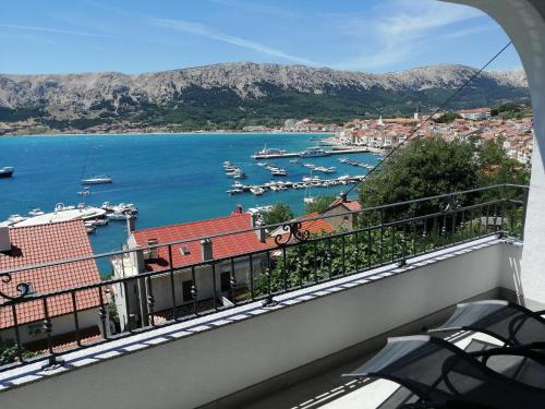 a balcony with a view of a harbor and boats at Apartments Andrea in Baška