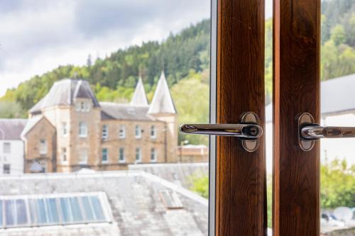 a window with a view of a large building at Crown Hotel in Callander