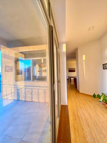 an empty hallway with a glass door in a house at Gobi-Girl in Ulaanbaatar
