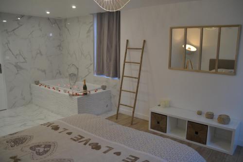 La salle de bains est pourvue d'un lit, d'une baignoire et d'une échelle. dans l'établissement Triplex 110 m2 centre historique avec jacuzzi DINAN, à Dinan