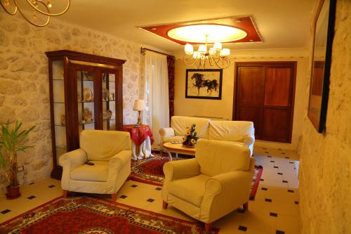 a living room with two chairs and a table at Agriturismo Monticelli in Mussomeli