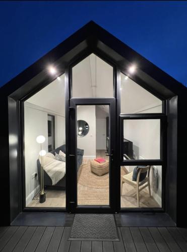 a room with a large glass door with a bedroom at Water Cabin With Water Sports Equipment and Bikes, Bath in Bristol