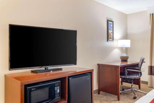a flat screen tv sitting on top of a wooden entertainment center at Comfort Inn & Suites Macon North I-75 in Macon