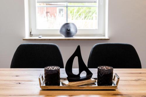 a tray of shoes on a table with chairs at Sylt Seascape III in Tinnum