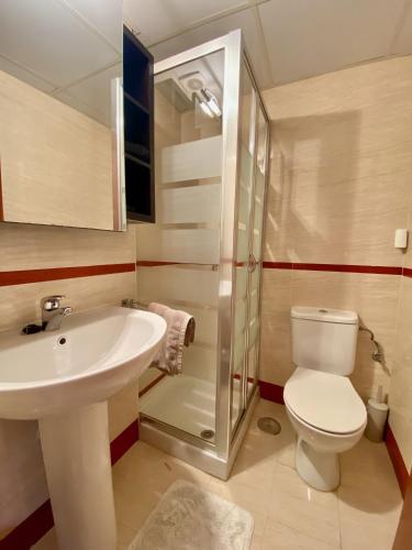 a bathroom with a sink and a toilet and a shower at Casa Toboso 2 in Torre del Mar