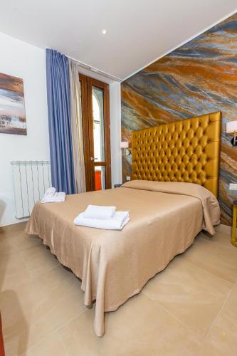 a bedroom with a large bed with a painting on the wall at Hotel Repubblica in Milan