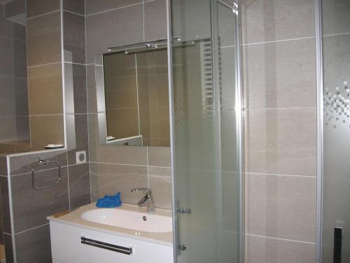 y baño con lavabo y ducha con espejo. en Gîte de Romagers, en La Chaze-de-Peyre