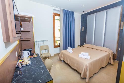 a hotel room with a bed and a table at Hotel Repubblica in Milan