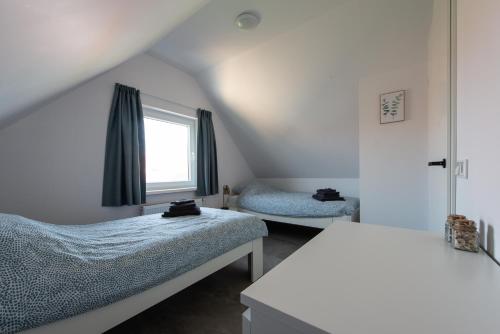 Katil atau katil-katil dalam bilik di Holiday Home 't Hout