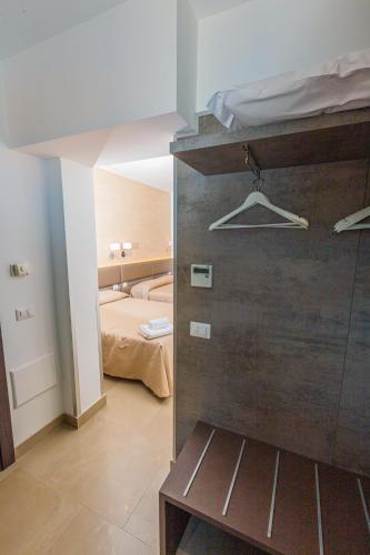 a room with a bedroom with a bed at Hotel Repubblica in Milan