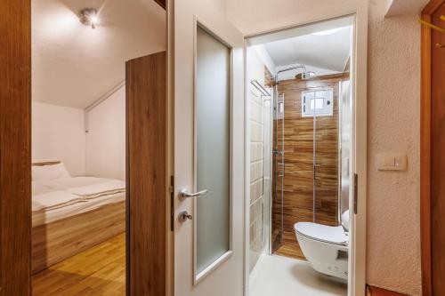 a small bathroom with a toilet and a shower at HOUSE MIRKO- center of Split in Split