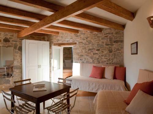 a living room with a bed and a table at Cressa Ghitonia Village in Sfáka