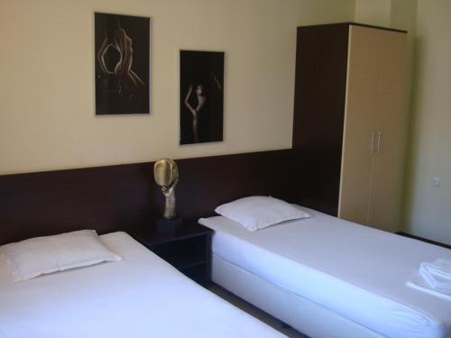 two beds sitting next to each other in a room at Guest House Lazur in Burgas City