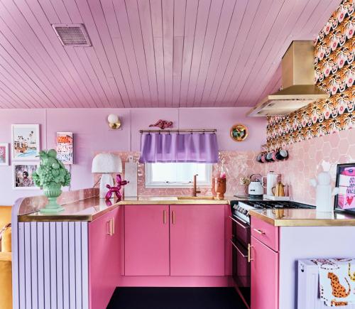 a pink kitchen with a sink and a stove at Fun Barbie Inspired, 6 Berth Caravan - Camber Sands Holiday Park, near the Beach in Camber