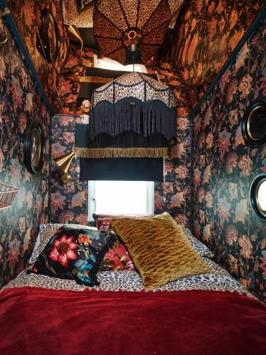 a bedroom with a bed in a room with wallpaper at Fun Barbie Inspired, 6 Berth Caravan - Camber Sands Holiday Park, near the Beach in Camber