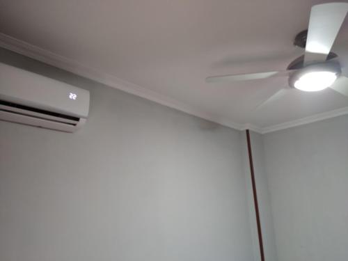 a ceiling fan with a light on a white ceiling at Hotel Europa in Tomelloso