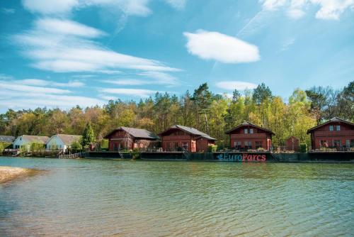 a group of houses on the side of a river at EuroParcs De Achterhoek in Lochem