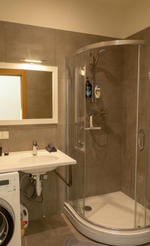 a bathroom with a shower and a sink at Cozy Apartment at Central Market - Liepajas heart in Liepāja
