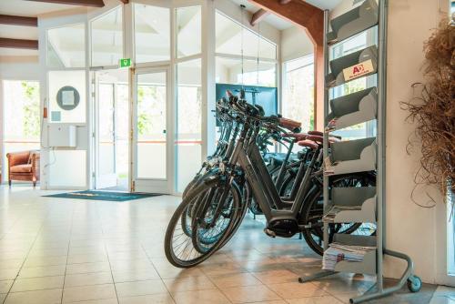 a group of bikes parked in a room at EuroParcs De Achterhoek in Lochem