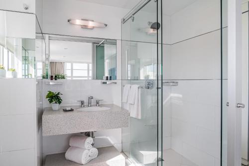 a bathroom with a sink and a glass shower at Clevelander Hotel in Miami Beach