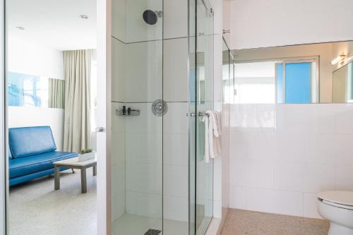 a bathroom with a glass shower and a toilet at Clevelander Hotel in Miami Beach