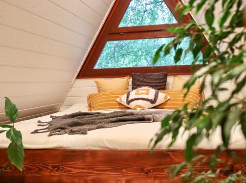 a bed in a room with a window at Utca végi házikó in Ásványráró