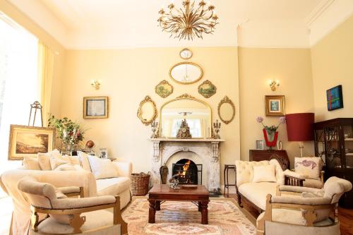 a living room filled with furniture and a fireplace at Annamult Country House Estate in Kilkenny