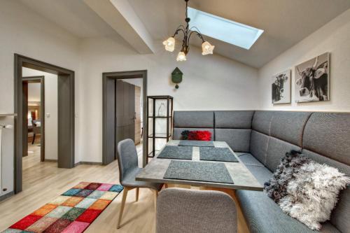 a living room with a table and a couch at Allgäuer Panoramahotel in Oberstaufen