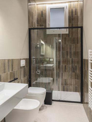 a bathroom with a toilet and a shower at Living u HomeSuites in Lecce