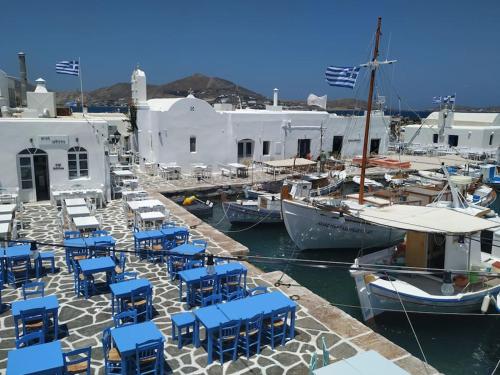 un grupo de sillas azules y barcos en un puerto en Evilou's House, en Krotiri